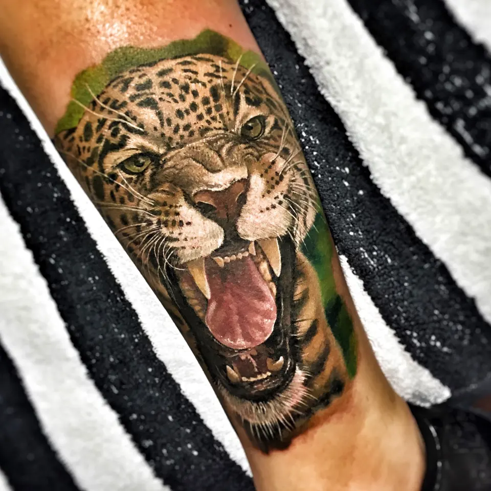 Fauchender Leopard als Realismus-Tattoo am Unterarm
